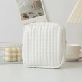 Detailed view of white quilted faux leather cosmetic pouch with elegant vertical stitching - White