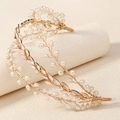 Close-up of golden bridal hair vine with delicate leaf design and white pearls - Gold Pearl Leaf