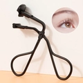 Close-up of black eyelash curler with silicone pad and result demonstration view - Sectional Black