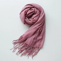 Solid smoky pink cotton-linen scarf featuring fringe trim in a circular roll display - Smoky Pink