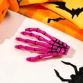 Pink skeleton hand hair clip on Halloween pumpkin and bat pattern background - Rose Red