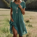 Detailed view of dark green short-sleeved polka dot dress with casual round neck style - XS / Top And Bottom / Green