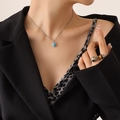 French vintage necklace with turquoise oval pendant and small diamonds on a model - Silver Blue Turquoise Necklace