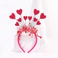 Detailed view of red glitter hearts and festive tinsel on a bright magenta headband - Rose Red Glitter Heart Tinsel Headband (No. 6)
