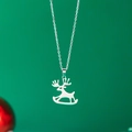 Silver stainless steel reindeer pendant necklace with hollow design on green background - Reindeer / Silver