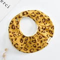 Detail of yellow leopard print cotton baby bib with adjustable metal snap buttons - Oval / Yellow