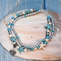 Double-layered silver anklet with turquoise beads and starfish charms on a shell - Hollow Heart