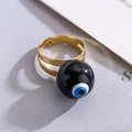 Macro shot of gold plated evil eye ring with black enamel bead and adjustable band - Adjustable Open / Black (13420)