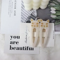 Pair of cream white cat hair clips with gold details on a fashion jewelry card - 2 Pcs/Set / Iridescent White