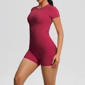 Detail of high-waist rose red yoga shorts and slim-fit tee with brushed texture - Carmine