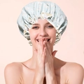 Detail of light blue floral shower cap with white ruffle edge on a model head - Fresh Blue