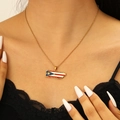 Detail of Puerto Rico map pendant necklace with flag colors worn by a model - 18K Gold Puerto Rico Style