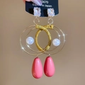 Detail view of pink teardrop pendant earrings with gold wire wrap and pearls - Silver Earring Post - Gold - Pink