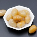 Polished natural yellow agate egg-shaped stones in a white hexagonal ceramic bowl - Topaz Jade (1pc)