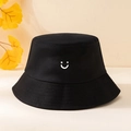 Detail of black cotton bucket hat with white smile print on a warm beige background - Printed Smiley Face Bucket Hat - Black / One Size