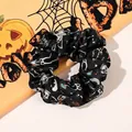 Detailed view of Halloween silk scrunchie with skull and music notes pattern on orange background - Skeleton Figure / Large Size
