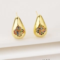 Macro detail of gold-plated drop earrings with a colorful zircon clover flower inlay - Colorful