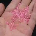 Pink transparent 2mm glass seed beads for DIY jewelry making held in palm - 2mm / 15g / Light Pink