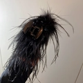 Close-up of elegant black ostrich feather hair claw clip with metallic spring detail - Black Feather Hair Claw