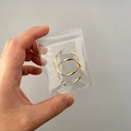 Golden twisted hoop earrings in a compact clear PVC plastic storage bag - 30 Micron 6x8cm Resealable / 100 Pcs/Pack