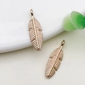 Pair of vintage gold-finished feather pendants for DIY jewelry making on white ceramic - 1pc Small Feather 6x20.6mm