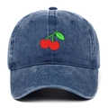 Detailed close-up of red cherry embroidery on vintage washed navy denim baseball cap - Navy Blue