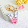 Resin letter V keychain with pink glitter sequins, pink tassel and golden moon charm - Letter V / Pink