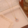 Detailed shot of star pendant necklace with pink stone and blue bead on a wooden tray - 8# Watermelon Red