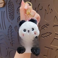 Plush panda keychain with black and white fur featuring a yellow banner with text - Plush Panda - Prosperity and Peace