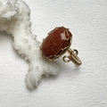 Macro detail of handmade 14K gold filled wire wrapped ring with brown sandstone - Gold Sandstone