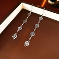 Macro view of silver tassel earrings with clover charms in a jewelry gift box - Ear Hook - Silver Rhombus Flower