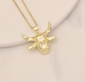 Detail shot of a golden bull head pendant with micro-set cubic zirconia on a fine chain - Geometric Cut Gold Bull Head Style (25#)