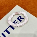 Pink elastic scrunchie with pleated fabric texture on beige paper packaging background - 1 Piece / Beige