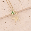Macro detail of butterfly rose pendant with green enamel and engraved clear gemstone - White