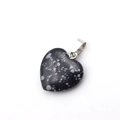 Black spotted natural stone heart pendant with silver metal bail on white background - Snowflake Obsidian