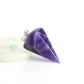 Macro detail of hexagonal cone amethyst pendant with faceted cut and silver metal bail - Purple Crystal