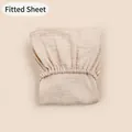 Detailed close-up of cream double gauze muslin cotton fitted sheet with elastic hem - Light Khaki / 81*41 cm