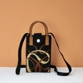 Close-up of a black knitted phone bag with geometric patterns and leather snap closure - Year of the Snake (Black)
