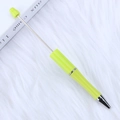 DIY beadable ballpoint pen in light green gradient with textured grip and silver accents - Bright yellow