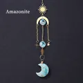 Amazonite crystal suncatcher with golden sun and moon pendants on a grey background - Amazonite Moon Wind Chime Pendant