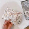 Close-up of floral canvas mini pouch with rabbit print and pink woven zipper pull - Cream Rabbit & Yellow Flower