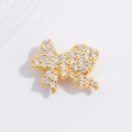 Elegant gold bow pendant with sparkling white cubic zirconia in high detail on white fabric - Gold Bowknot