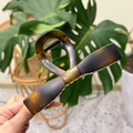 Macro detail of a large tortoiseshell bow hair claw clip with black metal spring mechanism - XL Straight Bow (13.5cm) / Matte Tortoiseshell