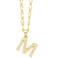 Detailed close-up of golden letter M pendant necklace with micro-paved cubic zirconia - Letter M
