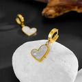 Detail of heart hoop earrings featuring gold metal finish and white shell inlays - White Hoop Earrings