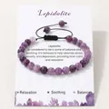 Detail of purple Lepidolite beaded bracelet on a relaxation and balance card - Phosphosiderite