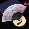 Chinese folding fan with white silk surface, pink plum blossoms and black tassel accent - Style 41