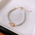 Elegant gold freshwater pearl bracelet featuring a pink gemstone center with crystal accents - #3 Bracelet - White - Round (gold Plated)