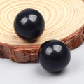 Polished round black onyx beads for DIY jewelry making on natural wood base - Obsidian