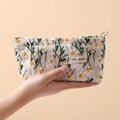 Cream canvas makeup bag featuring delicate daisy embroidery and a sturdy metal ring zipper - Daisy Small